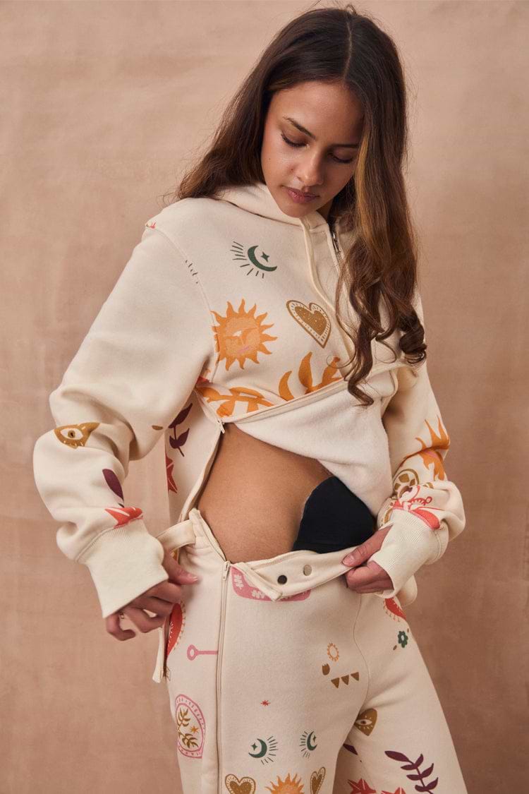 Cream Sundazed Accessible Joggers with NFD motifs, featuring side zips designed for medical treatment access.
