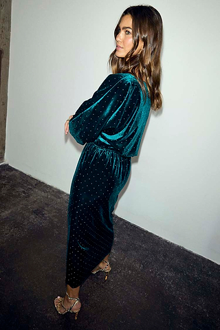 Emerald Velvet Tilly Dress with silver stud detailing and a voluminous top, shown from the side on a model.