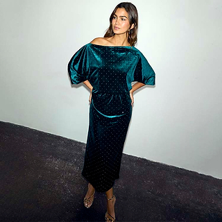 Emerald Velvet Tilly Dress Petite with a voluminous off-the-shoulder top and fitted skirt on a model.