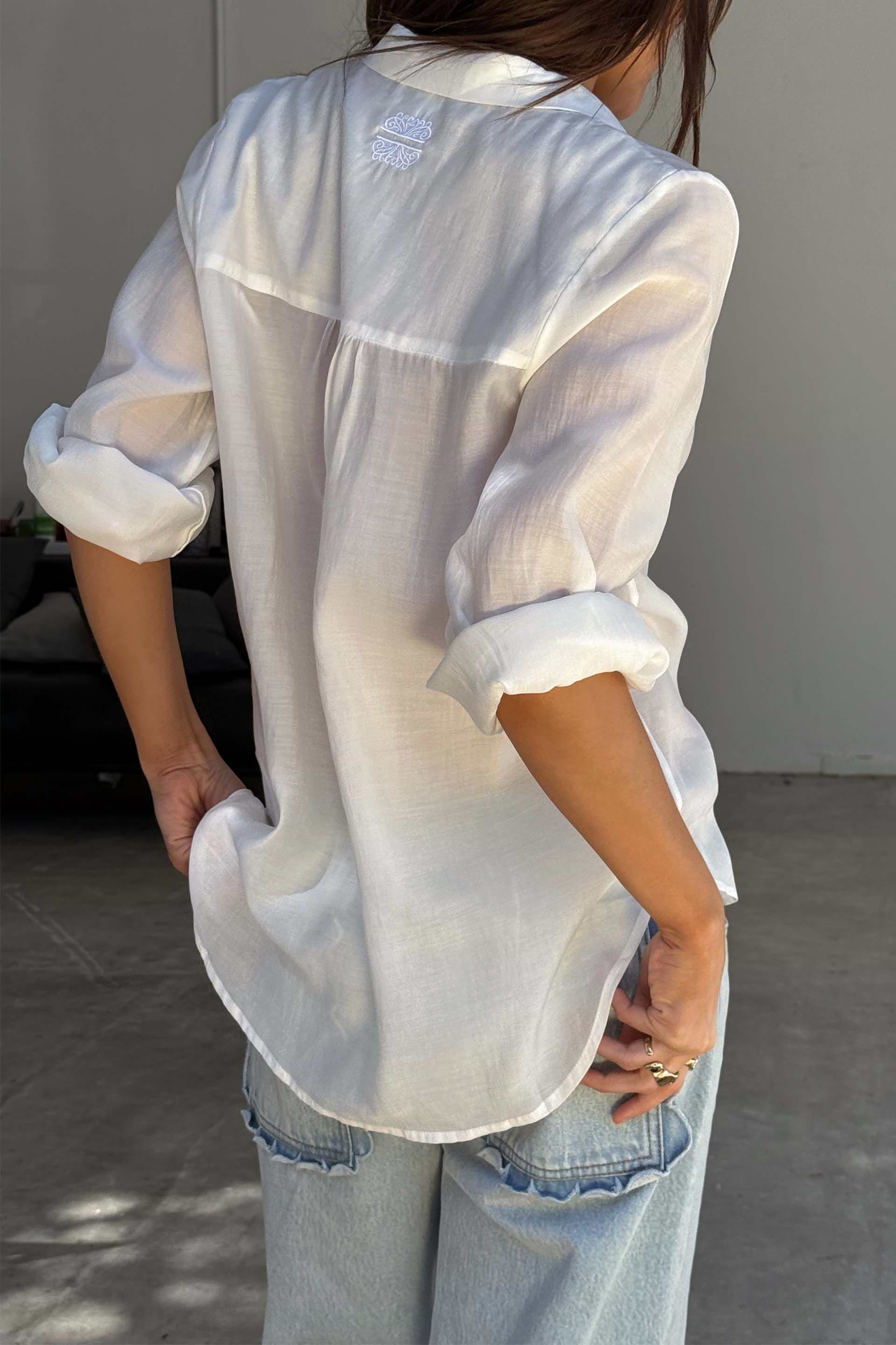 White Miley Shirt with embroidered back neck logo and rolled sleeves, showing its lightweight, oversized fit.