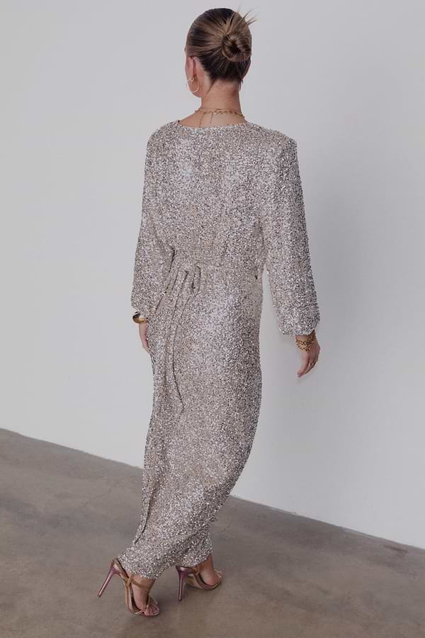 Silver Sequin Kira Wrap Dress with long sleeves and a wrap tie fastening, seen from the back.