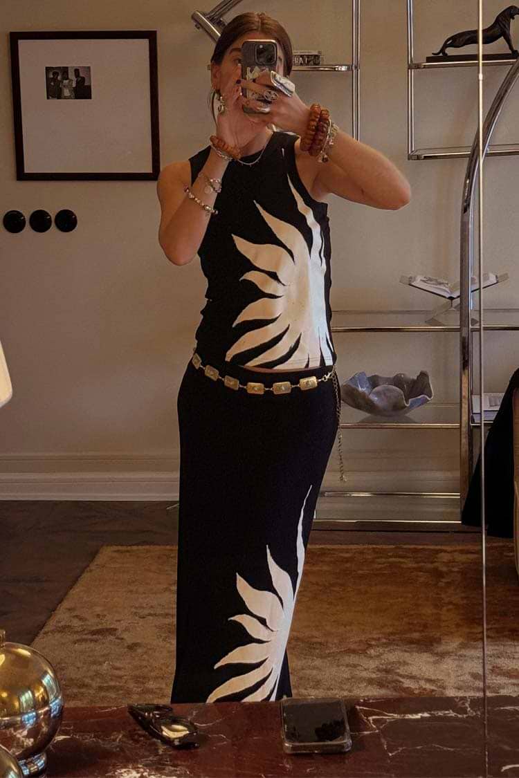 Black Sol Tank Top with a hand painted sun print, styled with a matching skirt and gold belt in a mirror selfie.