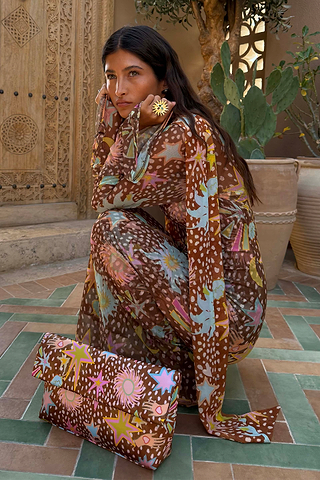 Brown Star Fawn Aria Mesh Dress featuring fawn spots and sun motifs, paired with a matching printed clutch bag.