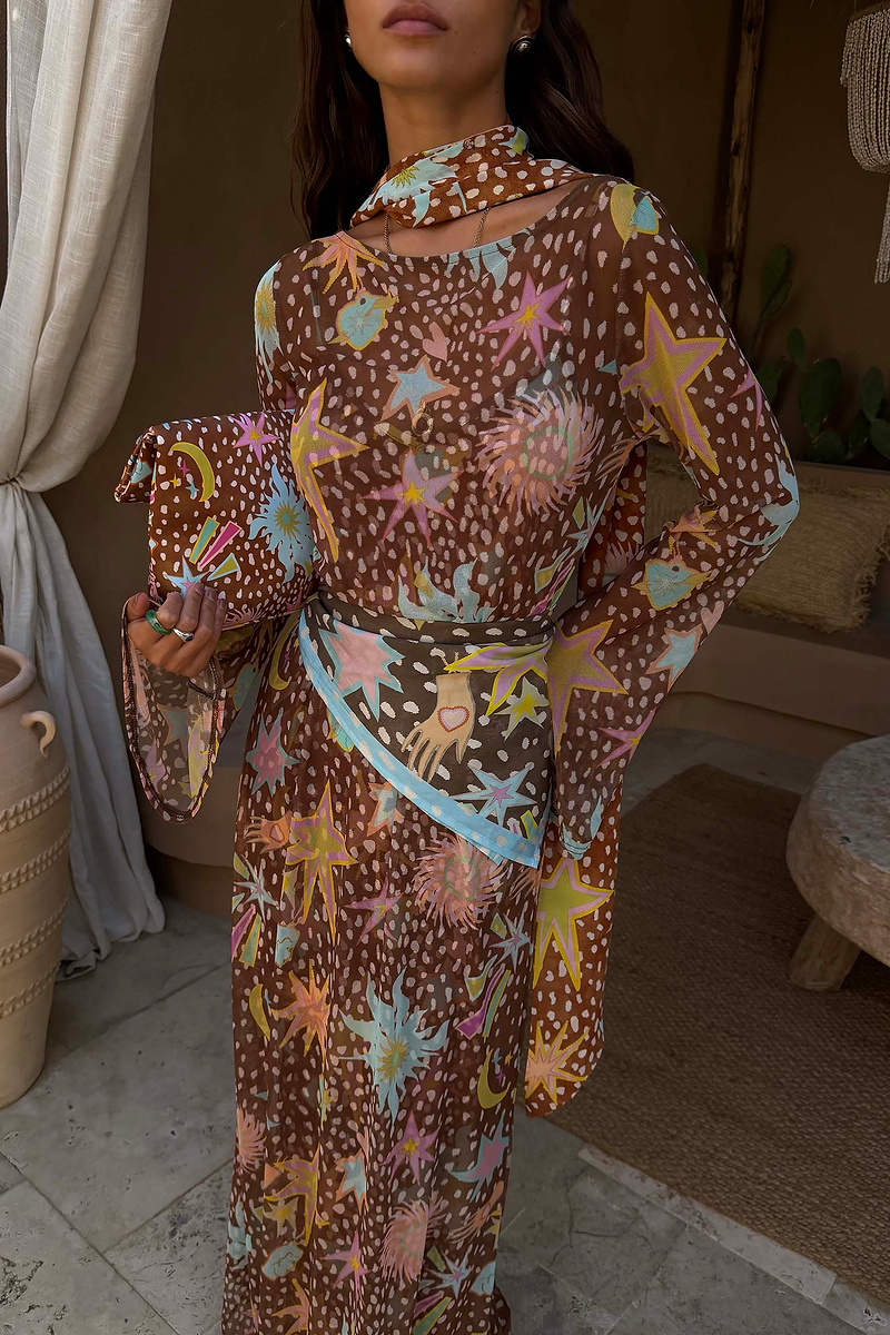 Star Fawn Aria Mesh Dress in brown with colourful celestial motifs, sheer fabric and flared sleeves.