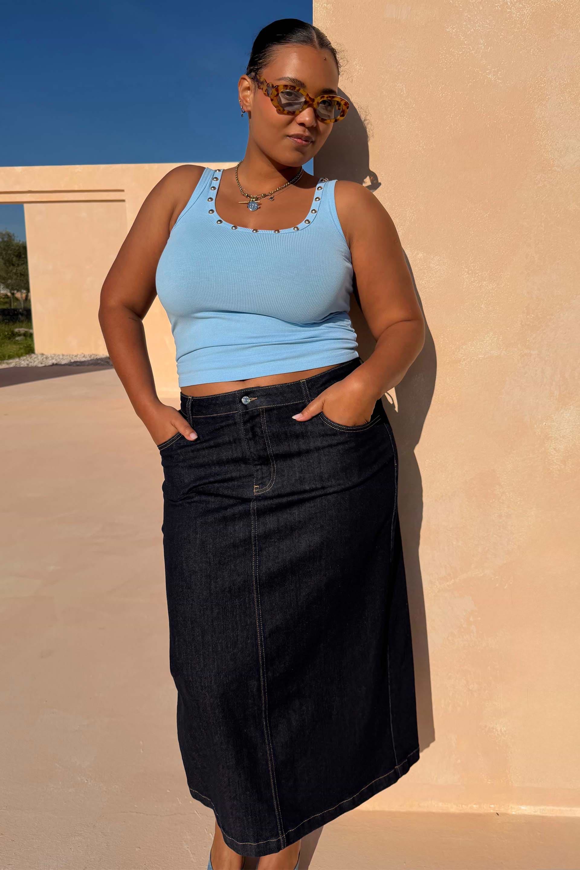 Ice Blue Studded Rib Vest with gold stud neckline detailing, styled with a dark denim skirt for a casual summer look.