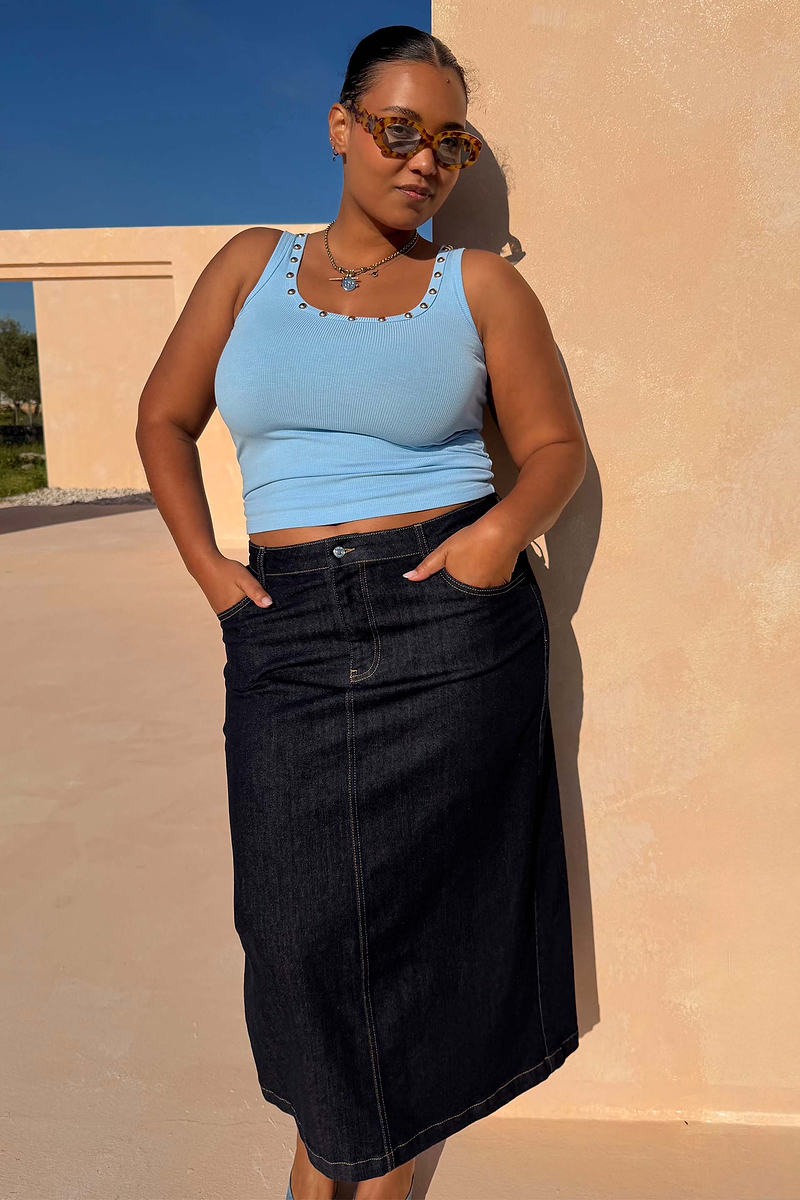 Ice Blue Studded Rib Vest with gold stud neckline detailing, styled with a dark denim skirt for a casual summer look.