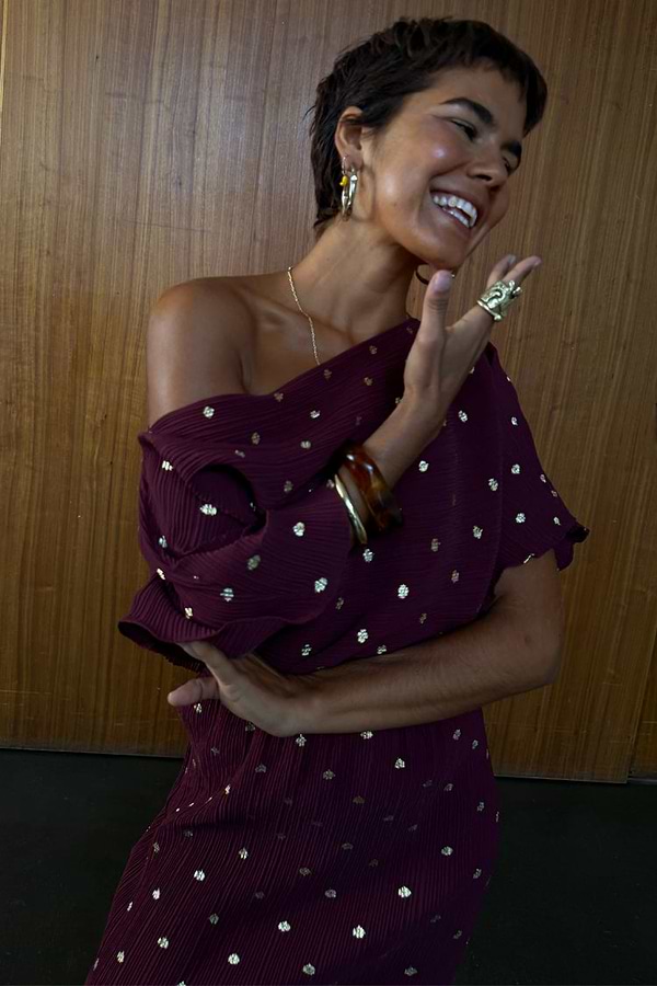 Burgundy Tilly Dress in gold-flecked plisse fabric, designed in London with an off-the-shoulder multi-wear neckline.