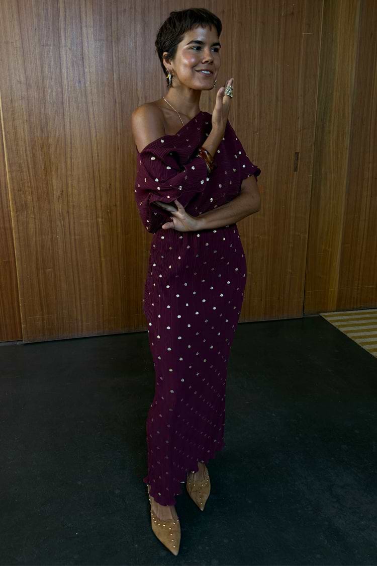NFD Burgundy Tilly Dress in gold-flecked plisse, featuring a multi-wear off-the-shoulder neckline and lettuce hem.