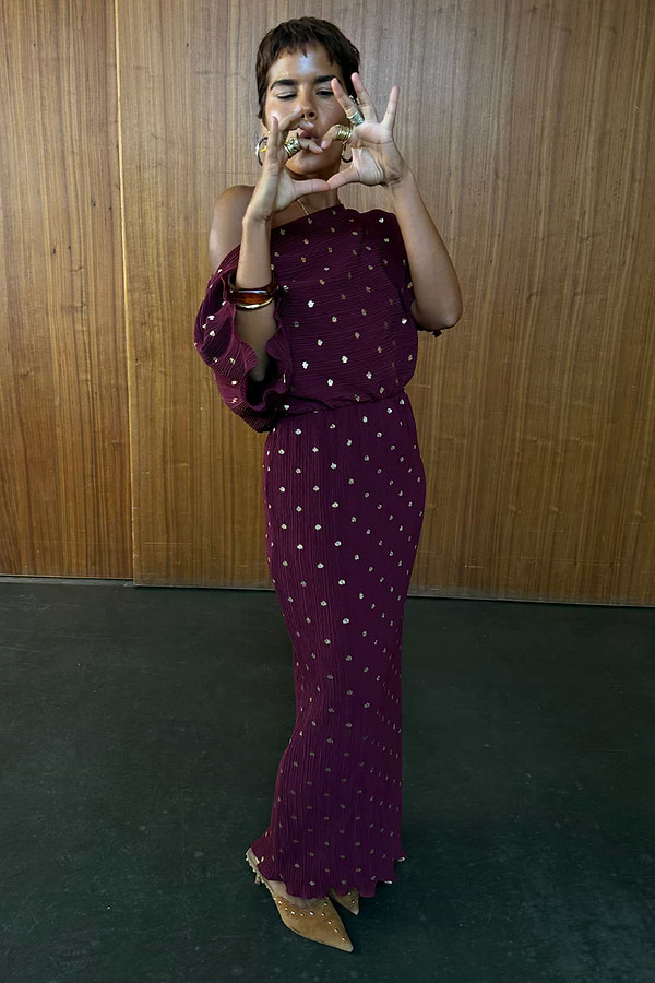 Burgundy Tilly Dress in plisse with gold flecks, featuring a multi-wear off-the-shoulder neckline.