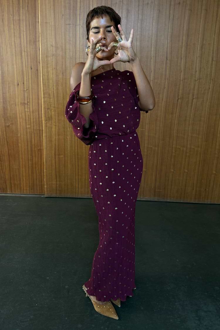 Burgundy Tilly Dress in plisse with gold flecks, featuring a multi-wear off-the-shoulder neckline.