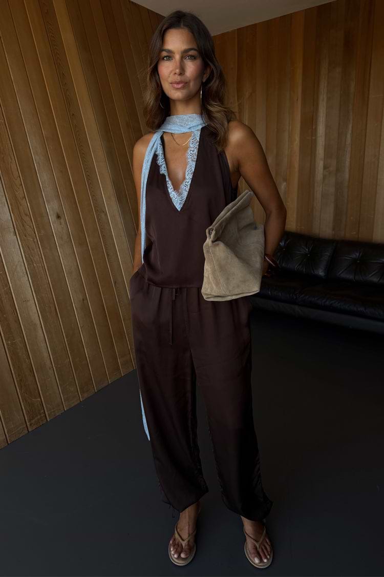 Chocolate Naomi Cargo Trousers in brown satin with a balloon leg and adjustable ties, styled with a matching lace top.