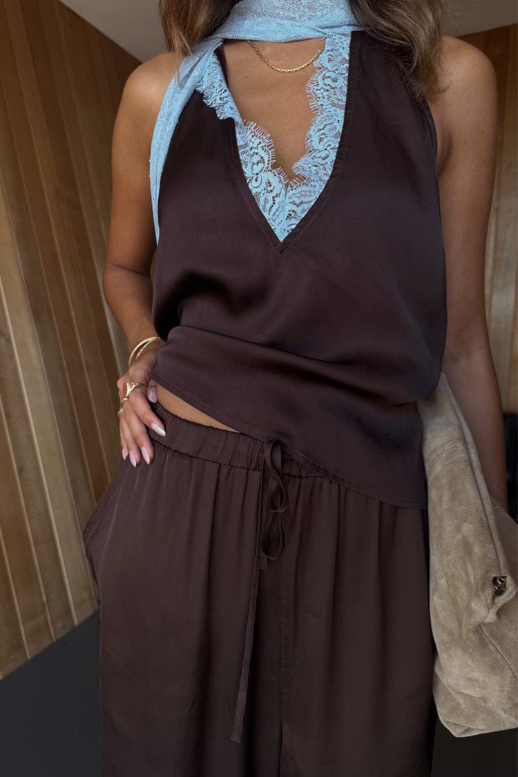 Satin Naomi Cargo Trousers in chocolate brown styled with a blue lace-trimmed top and neck scarf.