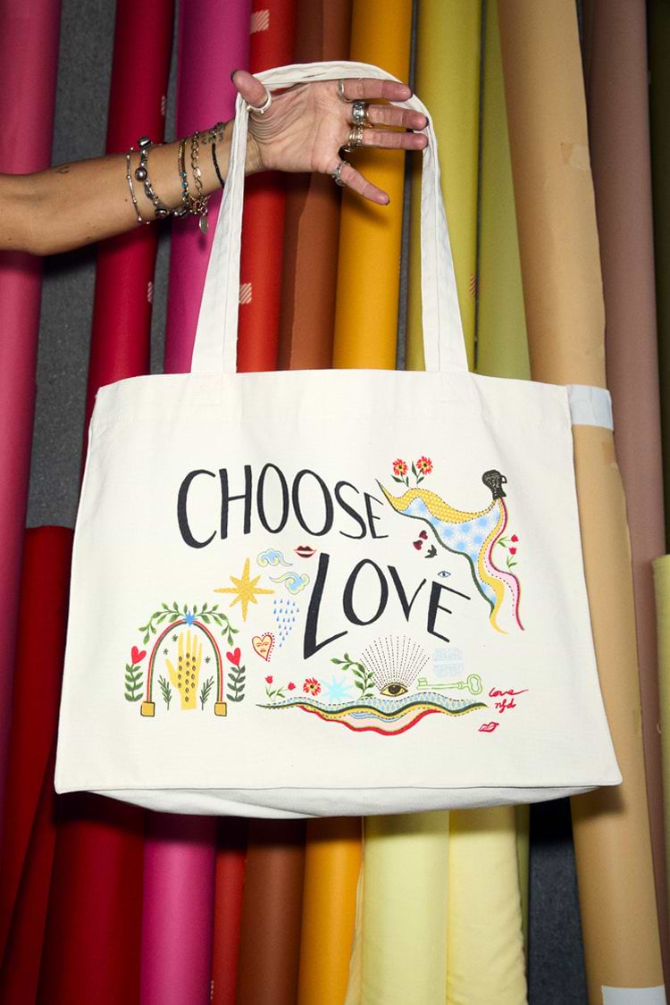 Choose Love tote bag in a recycled cotton blend featuring hand-drawn graphics against colourful fabric rolls.