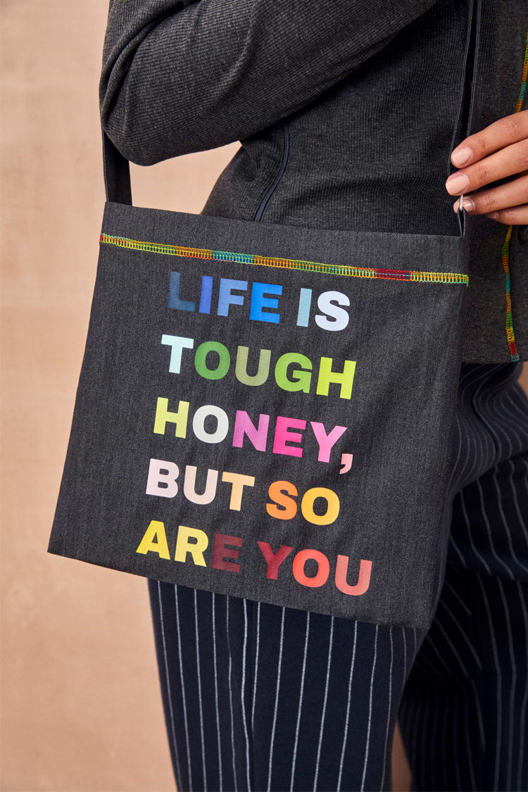 Charcoal Life is Tough Honey Drainage Bag with a rainbow 'Life Is Tough Honey, But So Are You' slogan and top stitching.