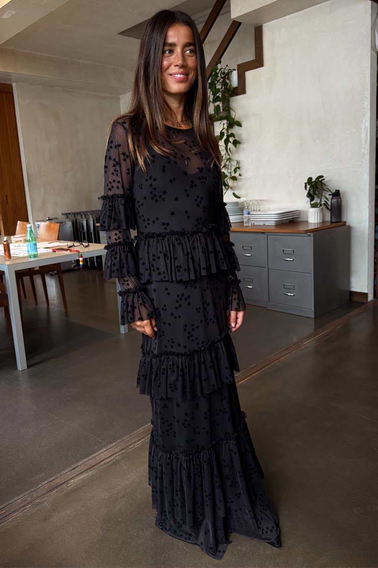 Black Star Devore Felicity Dress in mesh with velvet star motifs and tiered ruffle detailing on a model.