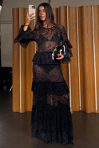 Black Star Devore Felicity Dress in sheer mesh with velvet star motifs and tiered ruffles, shown in a mirror selfie.