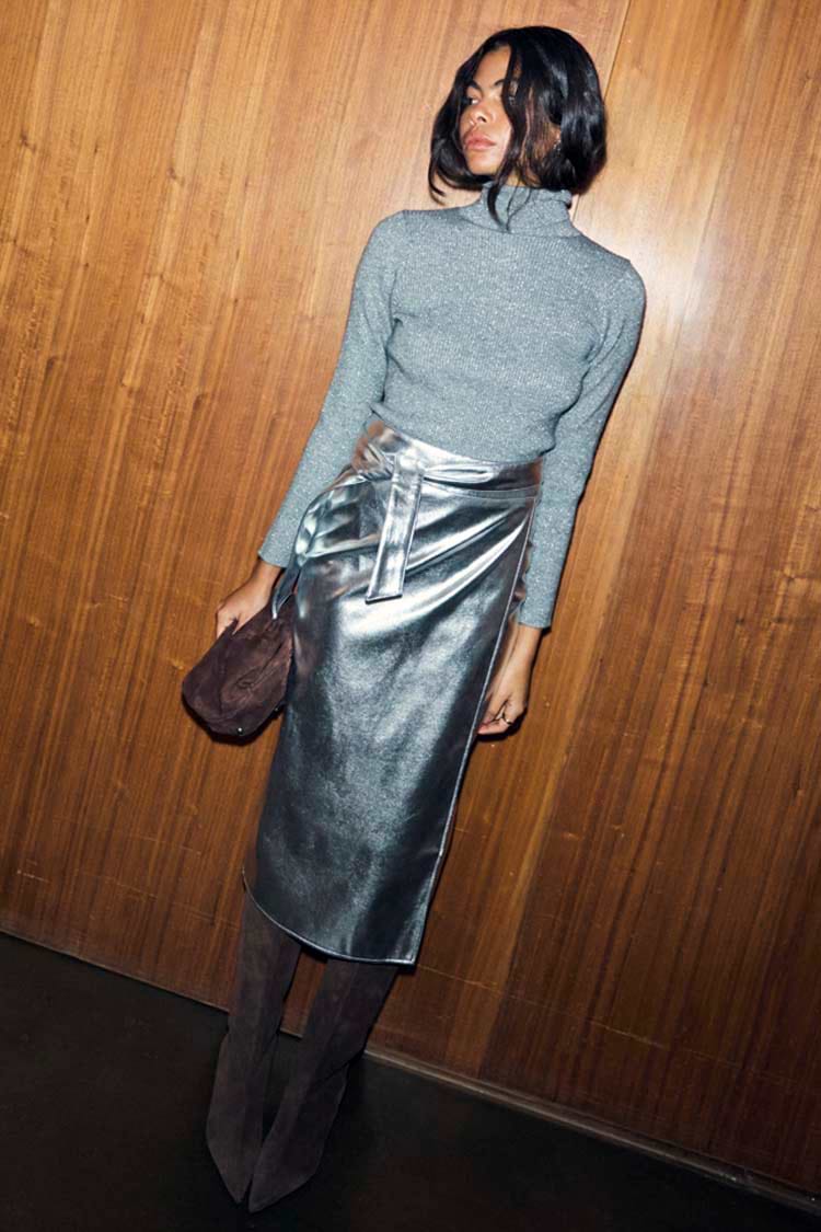 Gunmetal Rib Knit Jumper with a roll neck and silver shimmer, tucked into a metallic silver midi skirt.