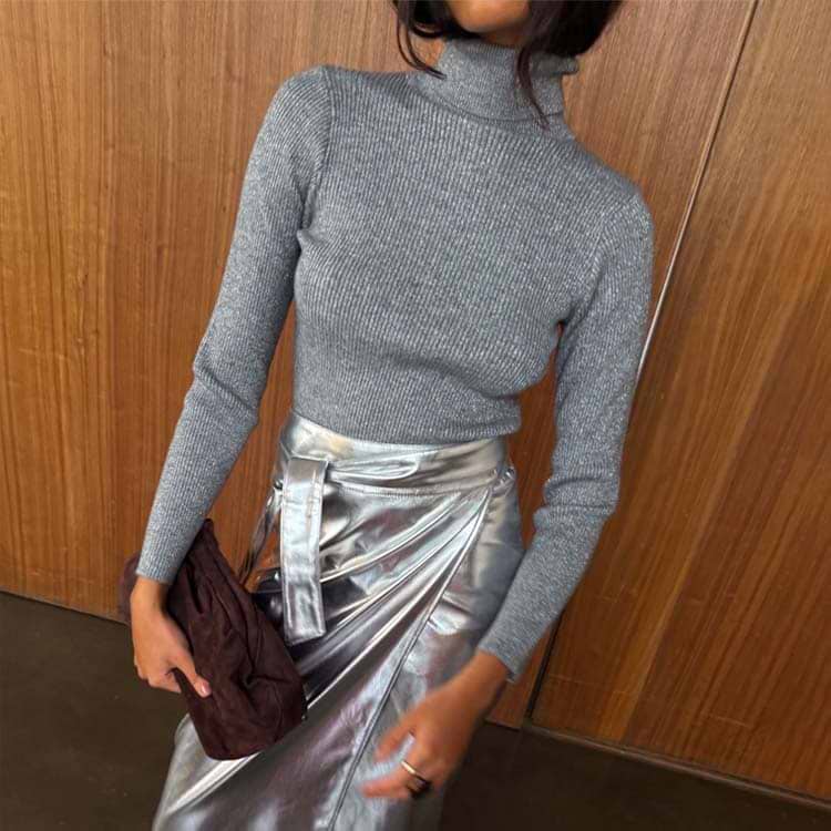 Gunmetal Rib Knit Jumper with a roll neck and silver shimmer, in a grey stretchy rib knit tucked into a silver skirt.