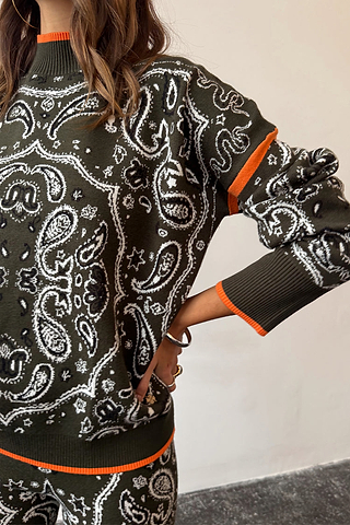 Khaki Bandana Dana Jumper with white bandana print, roll neck, and contrast orange trim on the cuffs and hem.