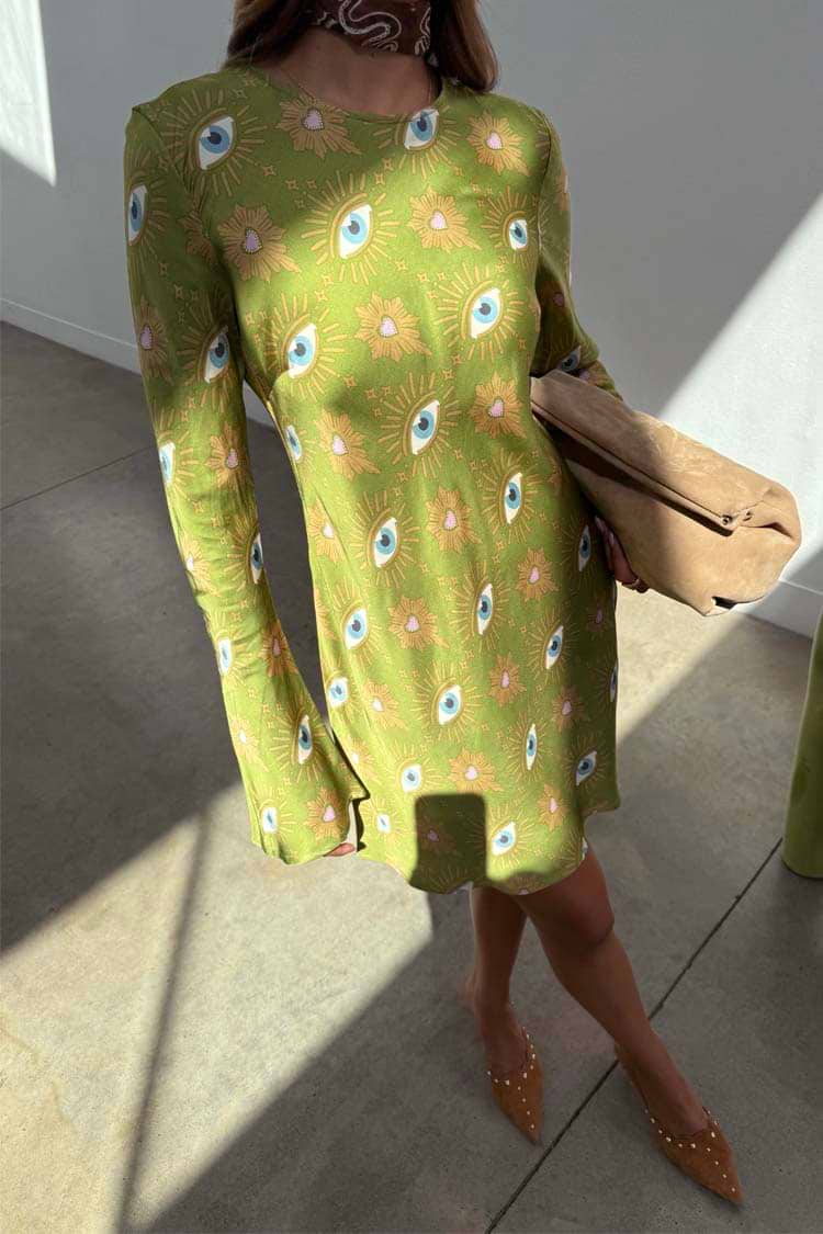 Khaki Eye Mini Soho Dress Petite featuring an iconic eye print and flared sleeves, styled with a tan clutch.