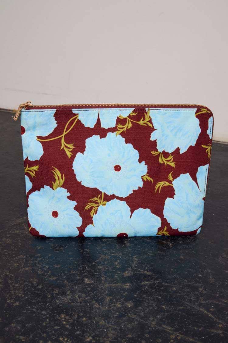 Blue & Burgundy Poppy Laptop Case featuring oversized light blue florals on a burgundy background with a gold zip.