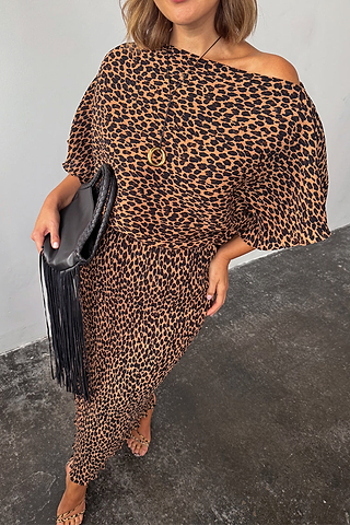 Lucia Leopard Tilly Dress in plisse fabric with an off-the-shoulder neckline and black fringed clutch.