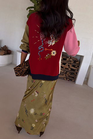 Olive Mystical Dorris Skirt in green with sun and moon motifs, styled with a colourful embroidered cardigan.