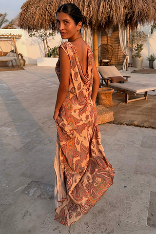 Peach Paisley Ava Dress featuring a draped cowl back and all-over paisley print, ideal for a vacation look.