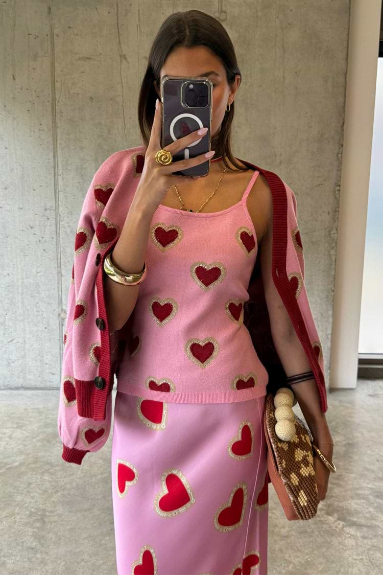 Pink Hearts Knit Tank with red heart prints, styled in a mirror selfie with a matching cardigan and skirt co-ord.