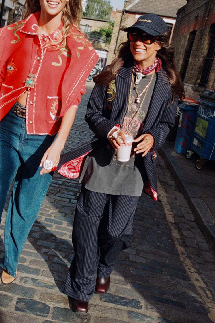 Navy Pinstripe Arden Trousers and matching blazer styled for London looks on a cobbled street.