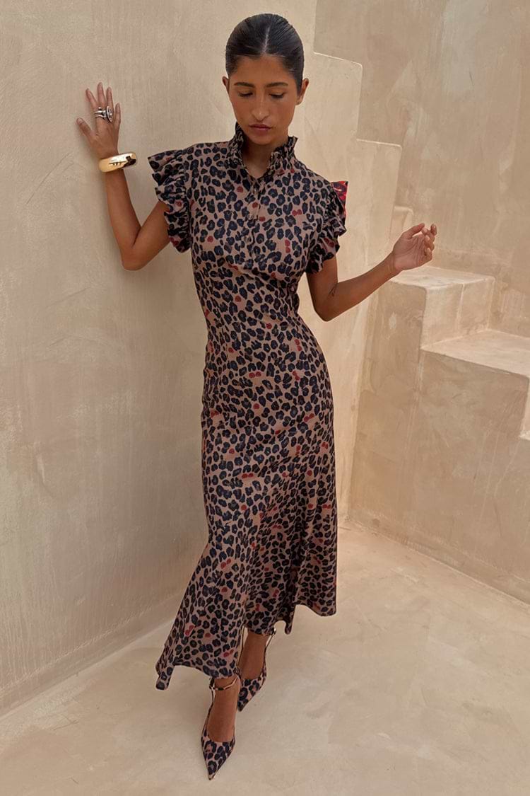 Cherry Leopard Remi Dress with a high neck, pleated frills and an asymmetrical skirt on a model.