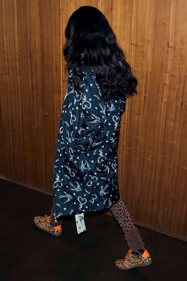 Mono Swallow Romance Reversible Coat with a black and white swallow print, shown on a model walking.