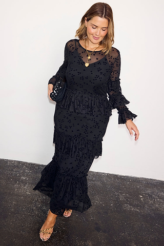 Black Star Devore Felicity Dress with tiered ruffles and velvet star motifs, worn by a size 18 model.
