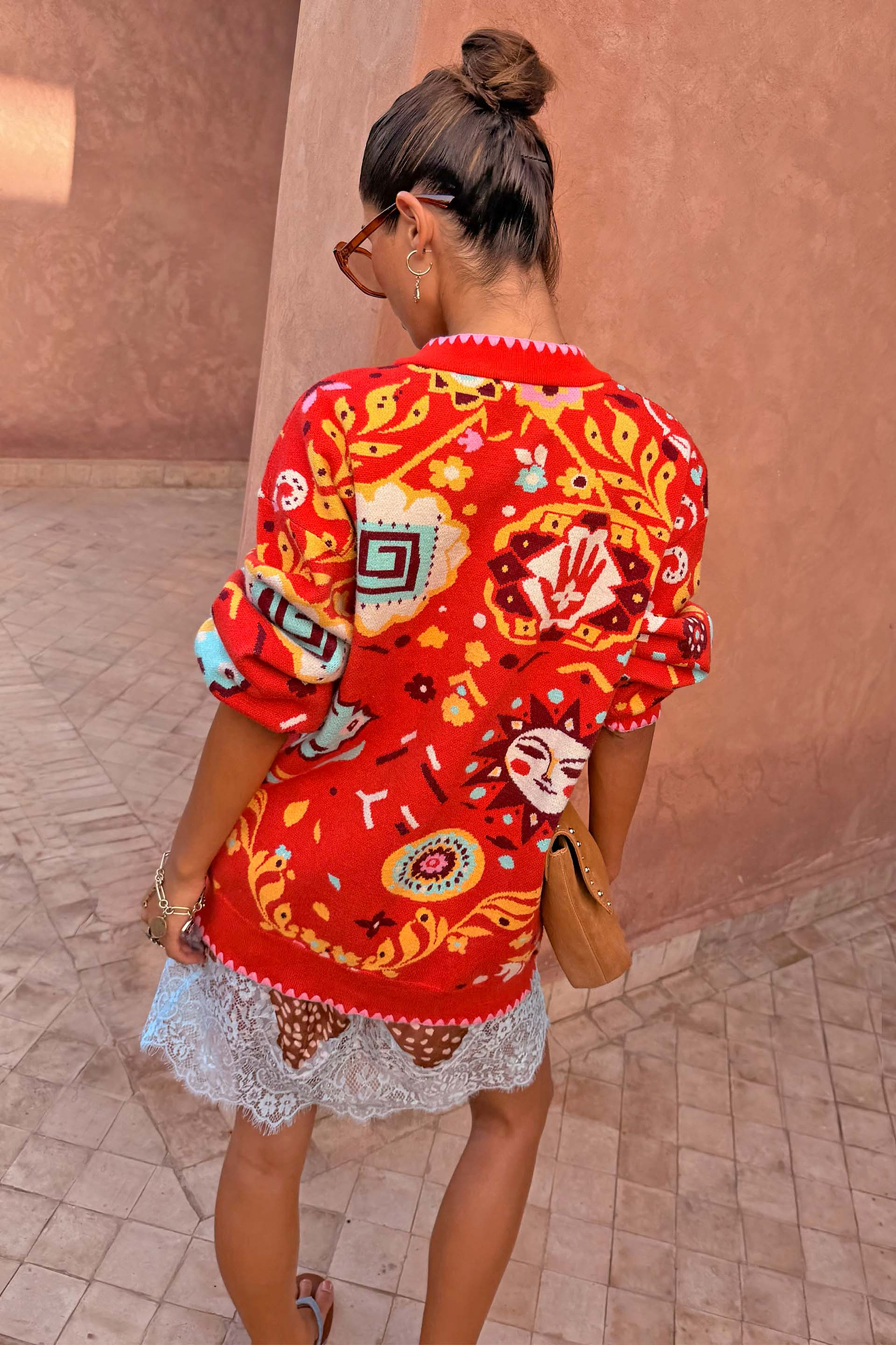 Tomato Tapestry Martha Cardigan in red with celestial sun motifs, shown from the back in a relaxed fit.
