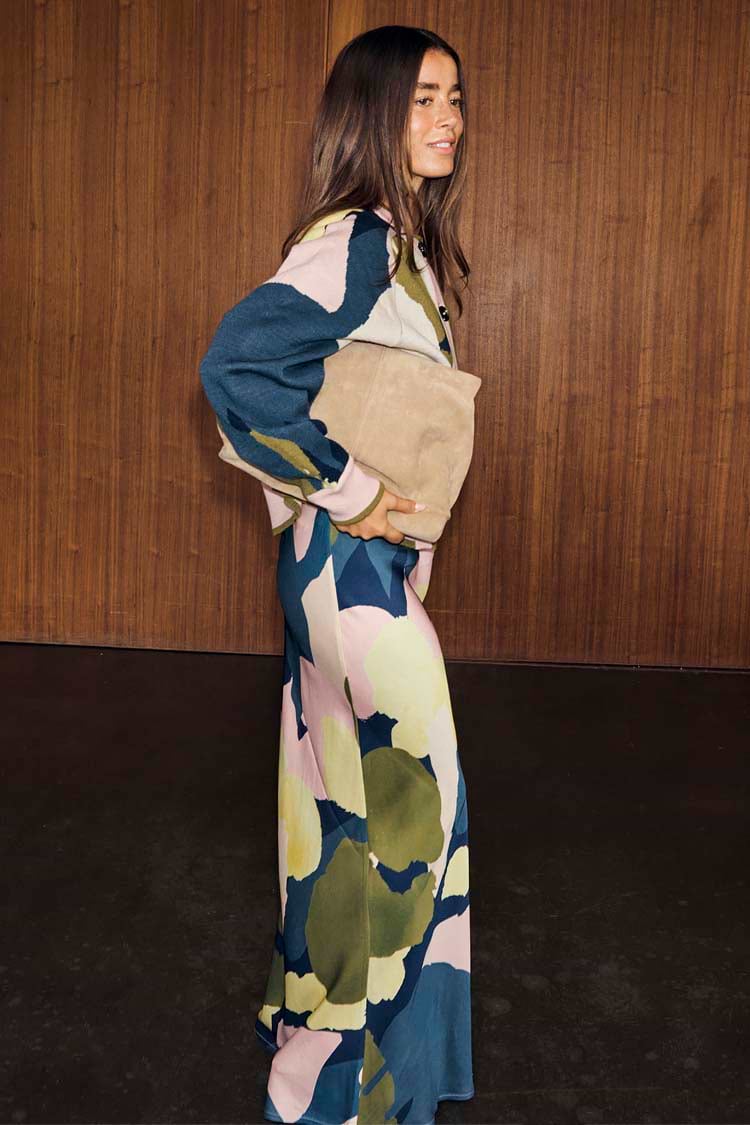 Teal Mara Abstract Dorris Skirt with a pink and olive print, styled as a co-ord with a matching top and tan clutch bag.