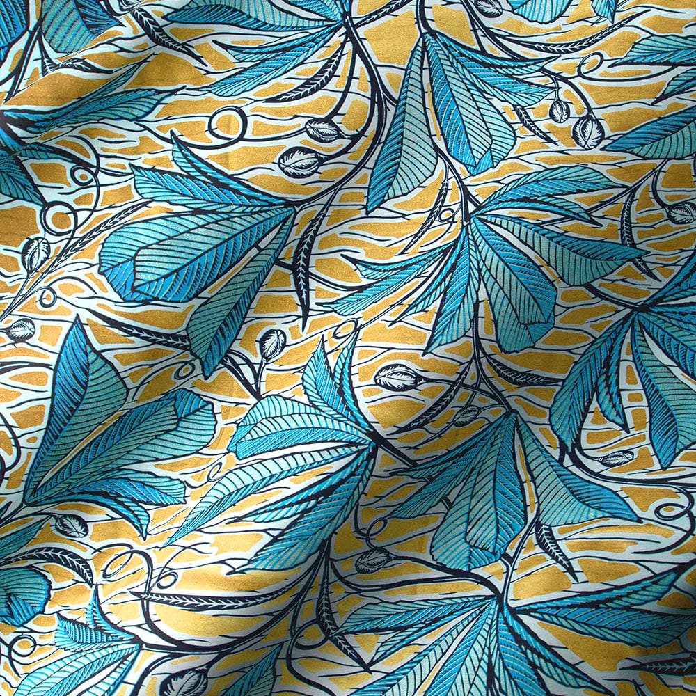 Gold patterned fabric with blue vines and leaves