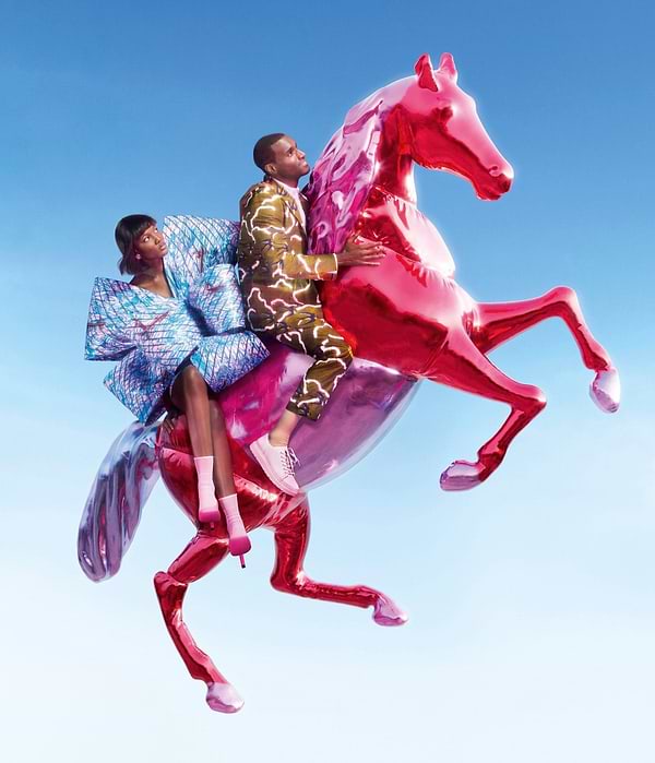 Photo of a woman and a man dressed in wax fabric flying on a blow-up horse