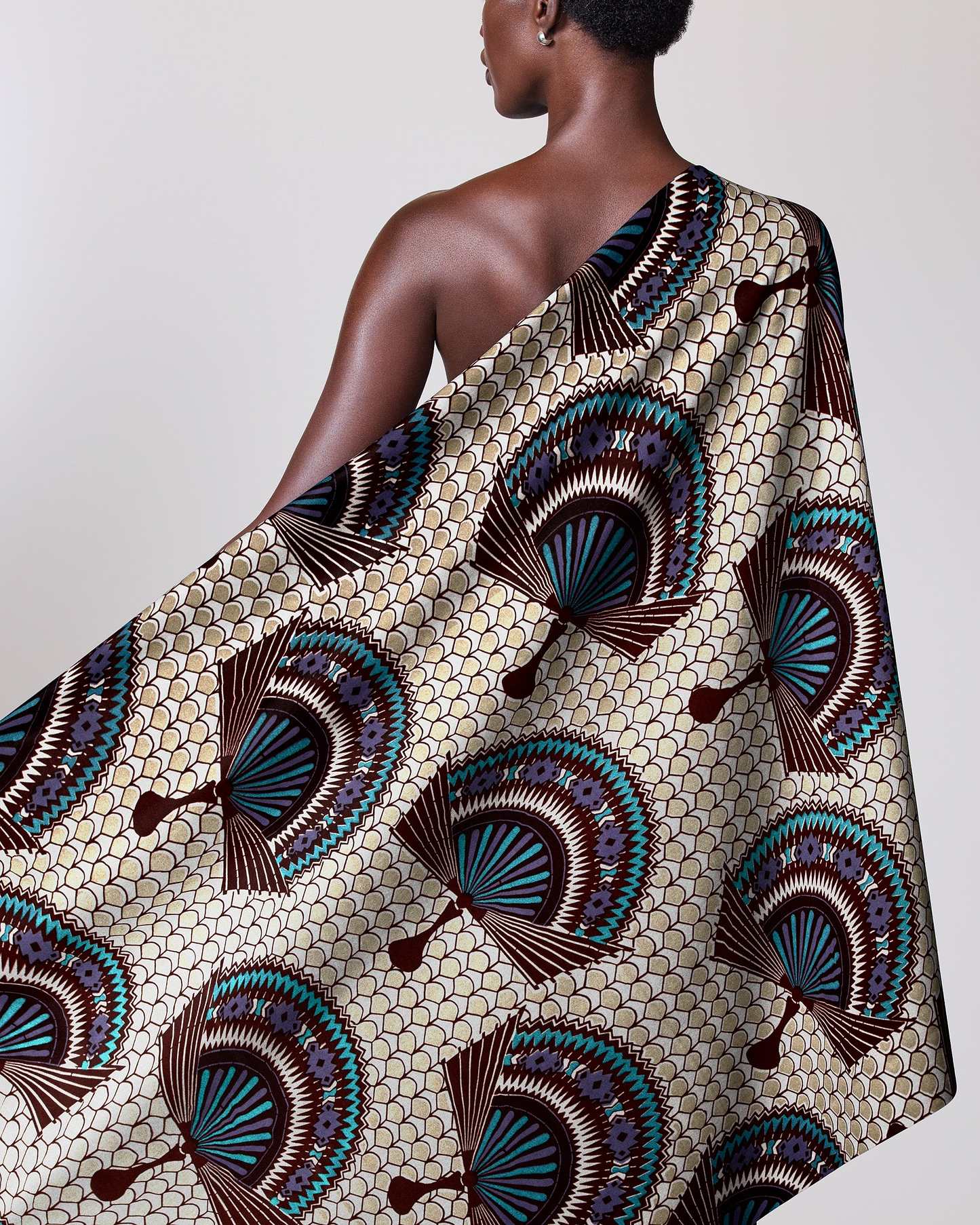 Woman wears one-shoulder garment made wax glitterglam vl08926.017