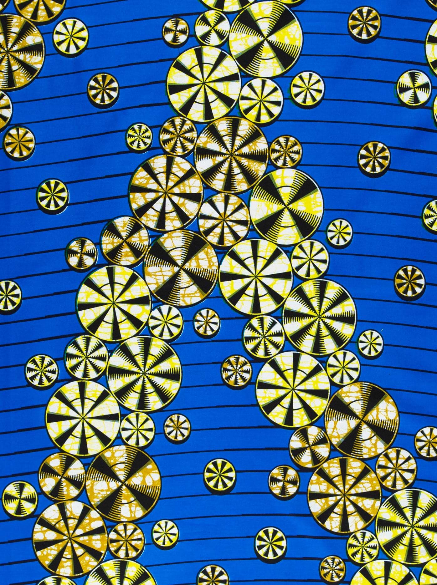 Blue fabric featuring yellow and black circular patterns with a bubble effect in expressive design