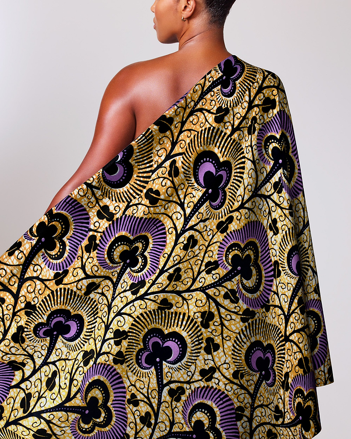 Woman wears vibrant one-shoulder wrap wax hollandais vlw7374.012