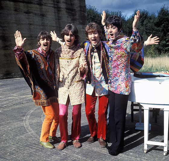 Photo of the Beatles dresses in wax fabrics next to a piano