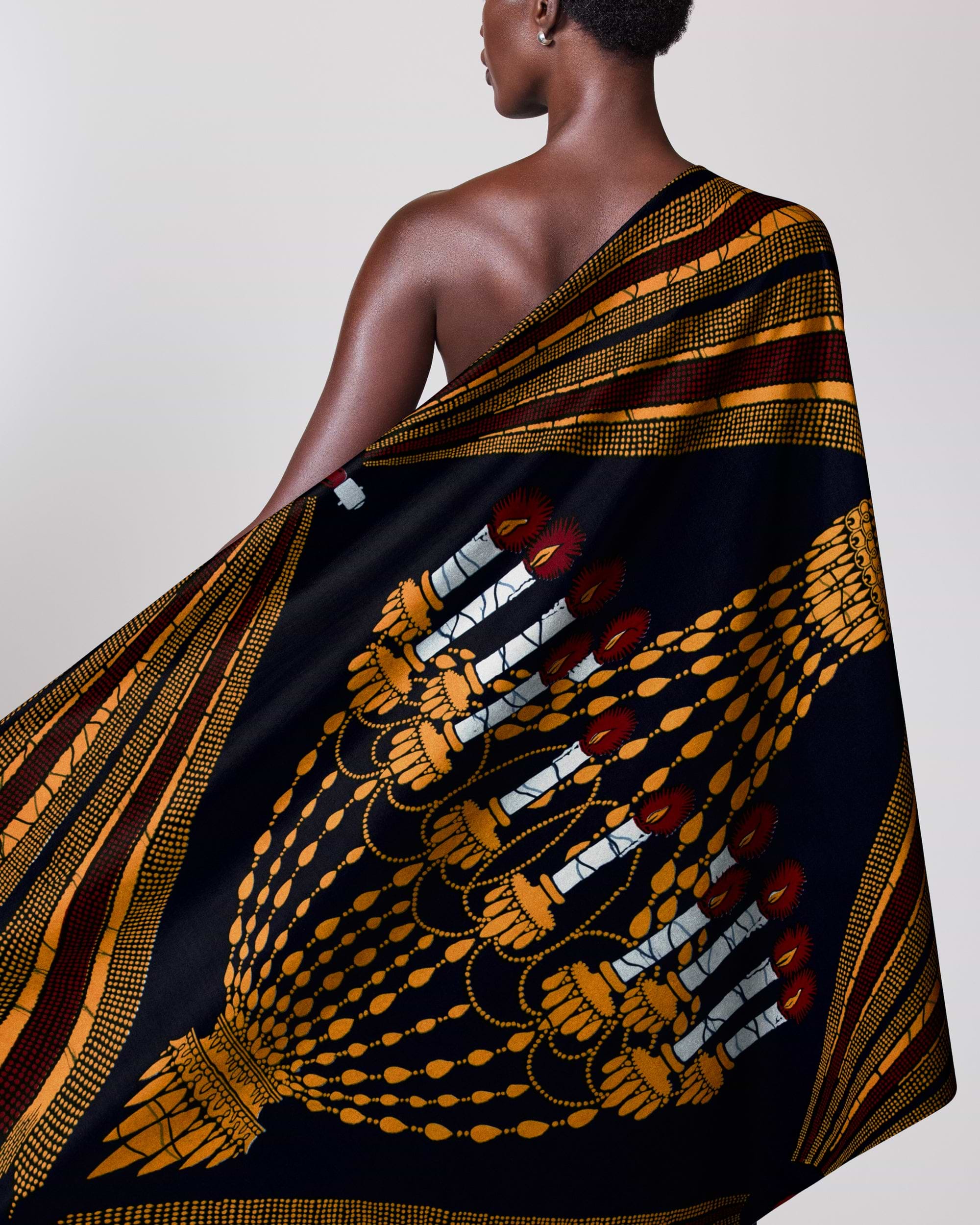Woman wears black gold maroon wax hollandais vl00927.080