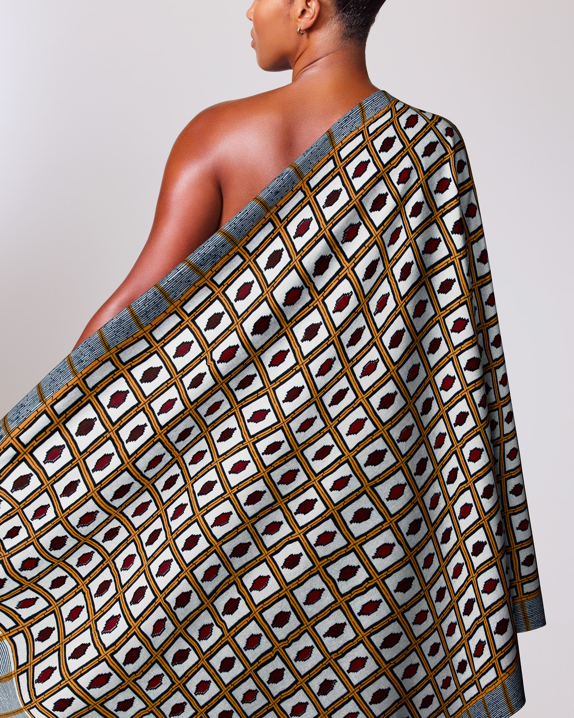 Woman wears one-shoulder wrap dress wax hollandais vl01630.027