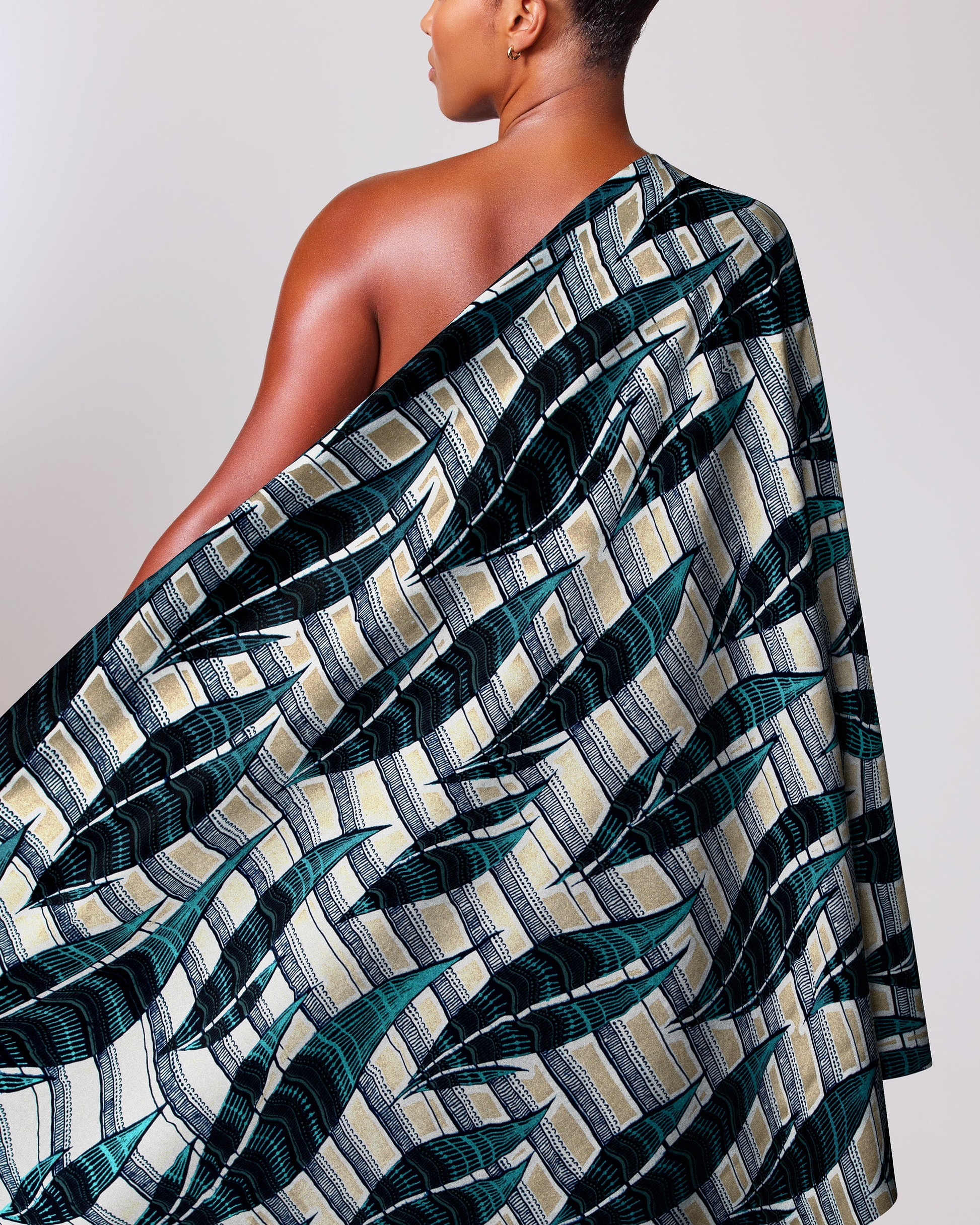 Woman wears one-shoulder garment made wax glitterglam vl08792.017