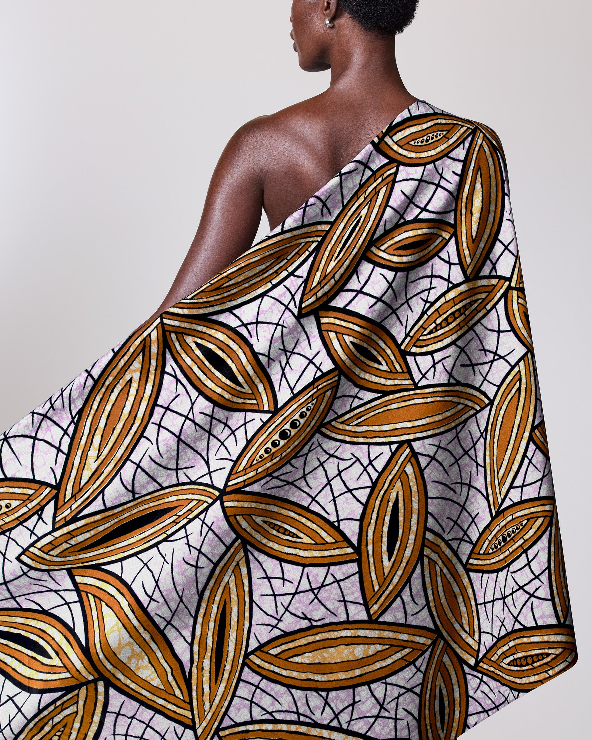 Woman wears one-shoulder wrap dress super-wax vls1884.009