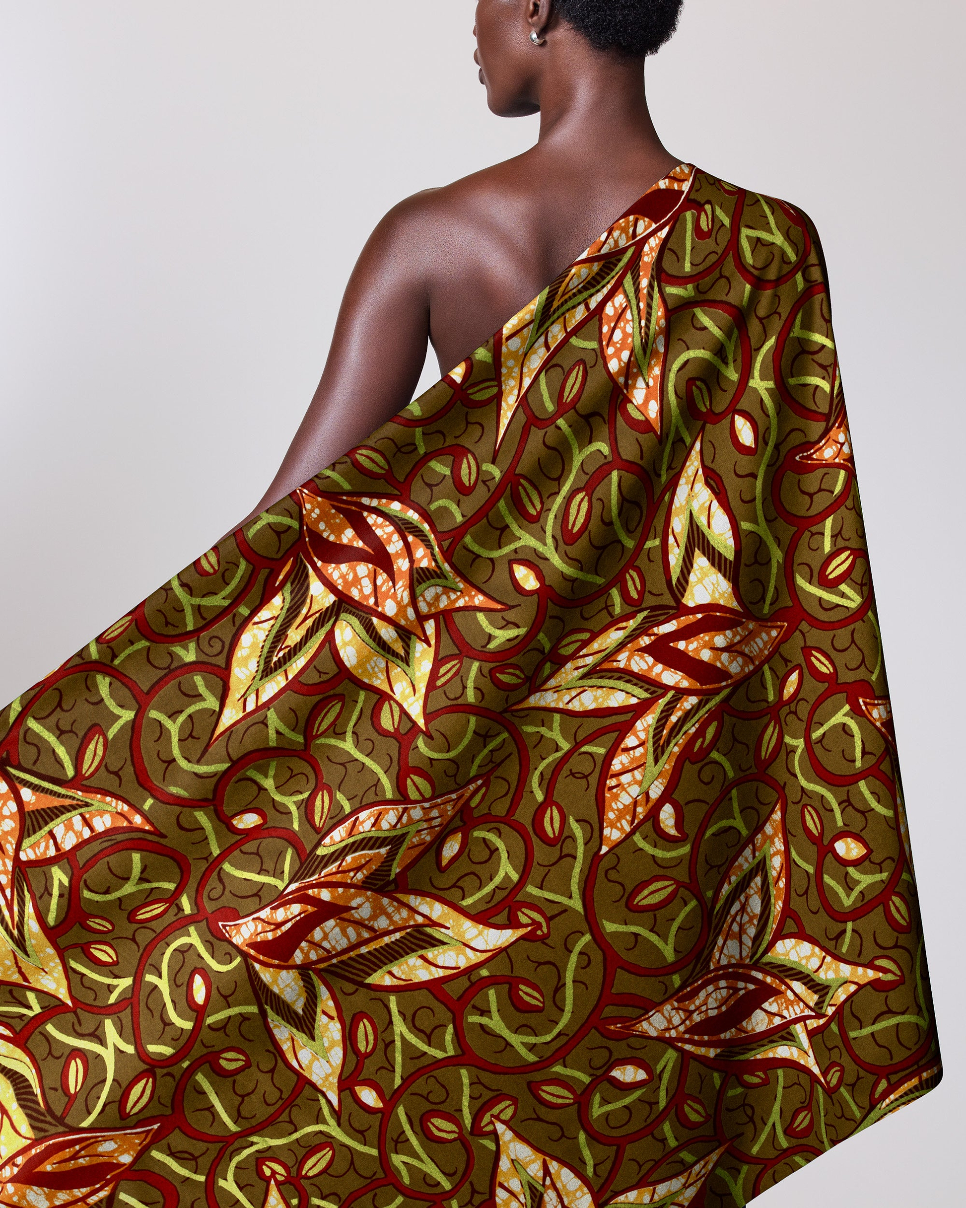 Woman wears one-shoulder garment made super-wax vls7382.010