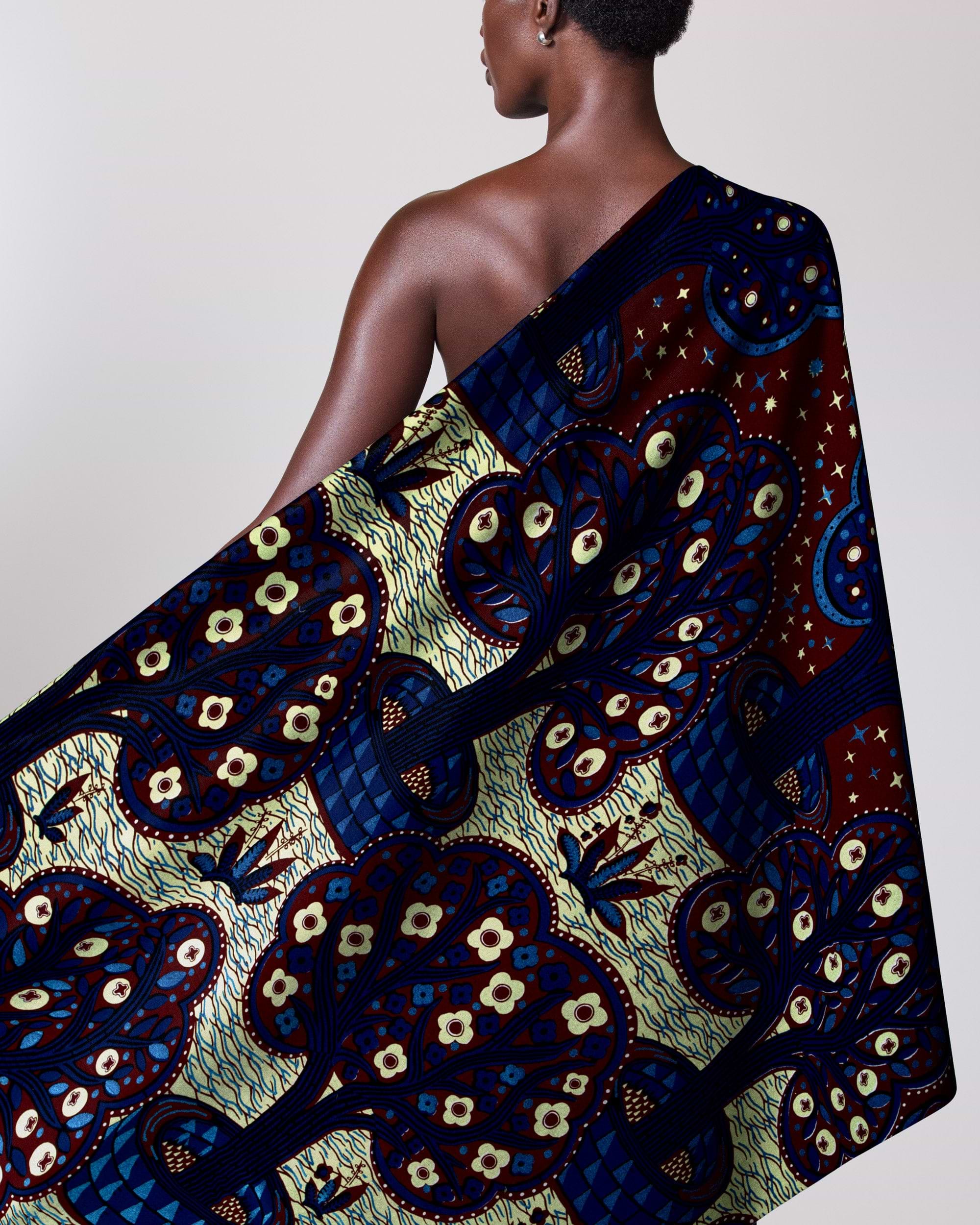 Woman wears vibrant one-shoulder garment wax hollandais vlw5403.002