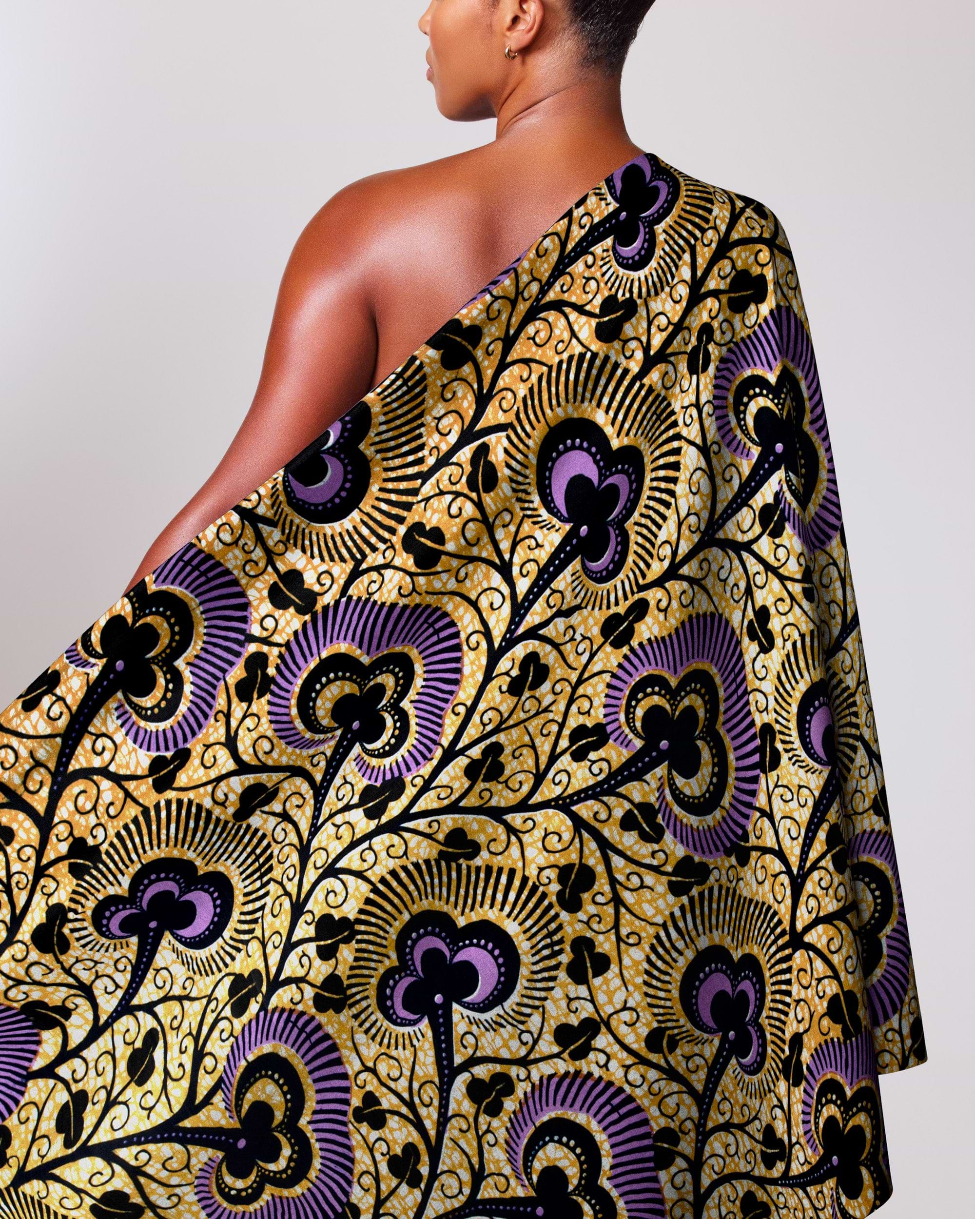 Woman wears vibrant one-shoulder wrap wax hollandais vlw7374.012