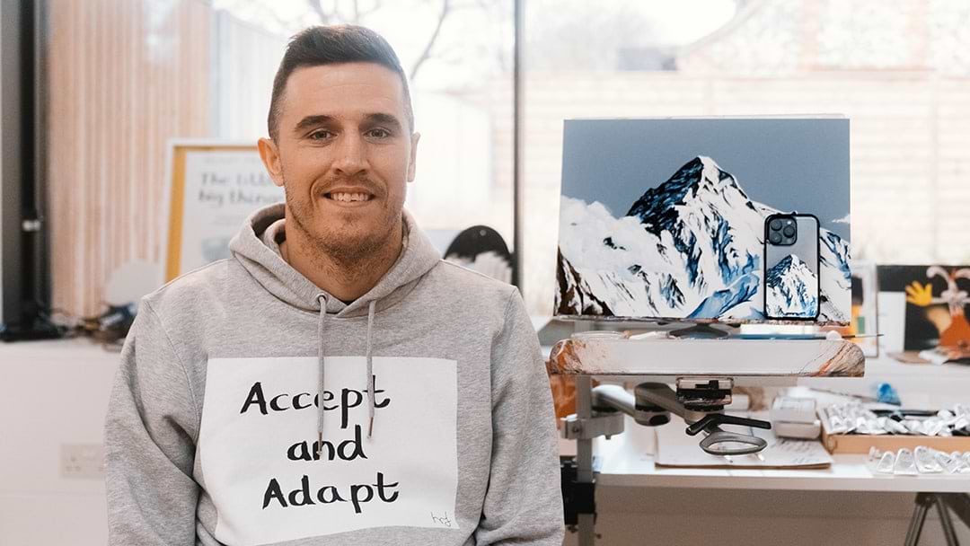 Image of Henry Fraser with his artwork and a Mous Collabs case