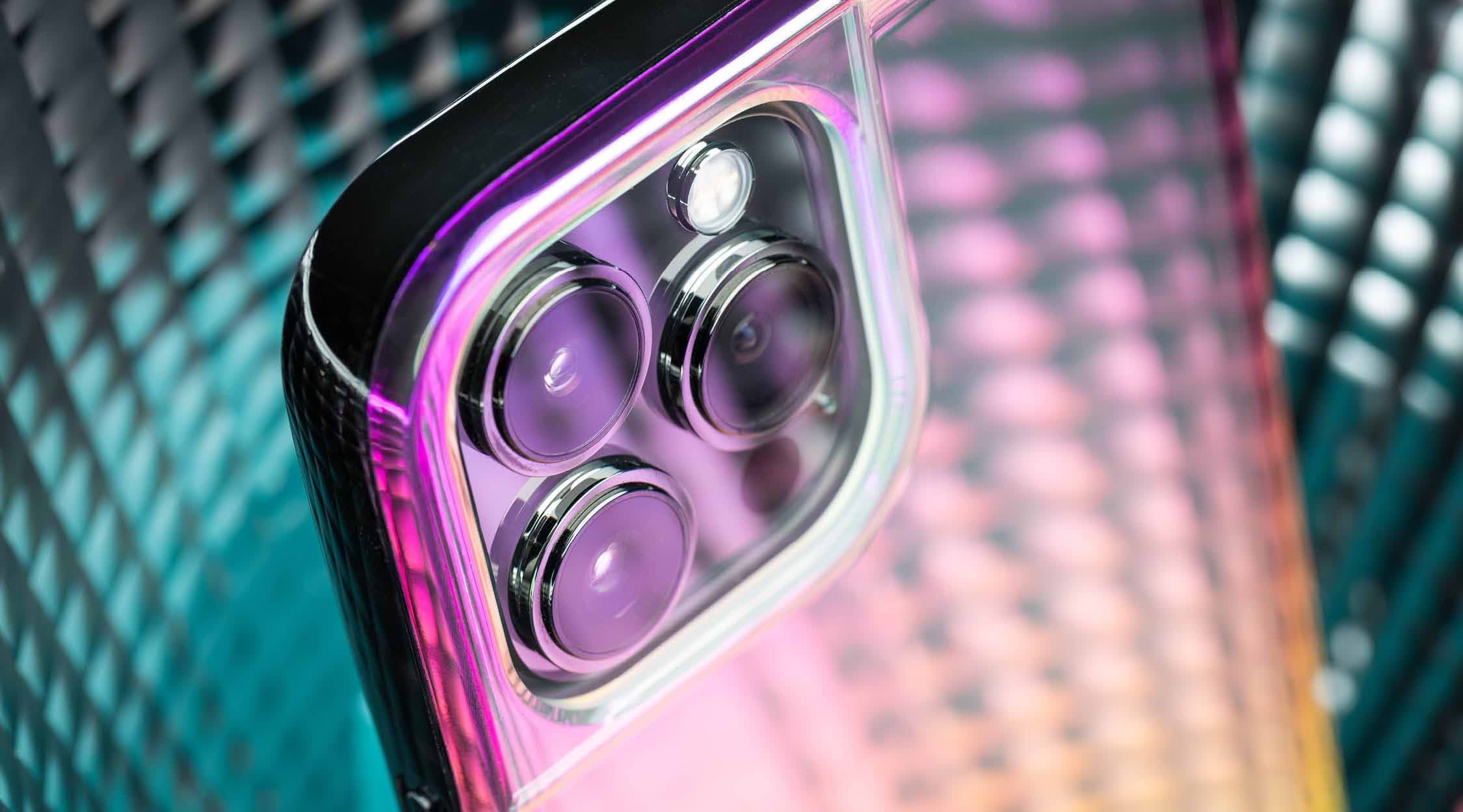 Pink and yellow iridescent phone case for iPhone 13 Pro Max on a blue background